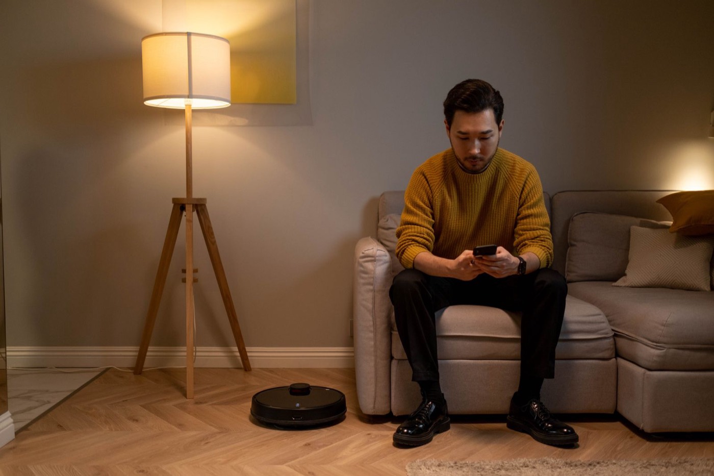 Man on a sofa reading marketplace messages on his phone