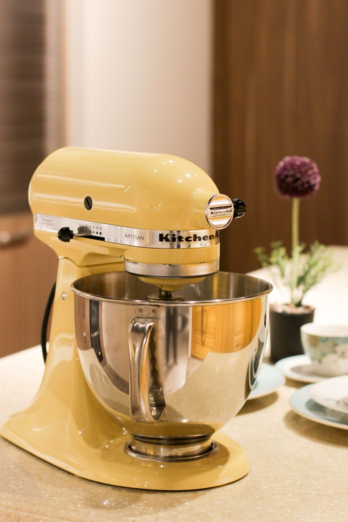 Yellow KitchenAid Artisan stand mixer on a counter